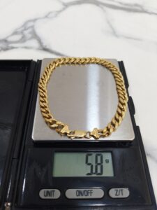 5.8g 18K yellow gold Cuban link bracelet 9 inches on a scale