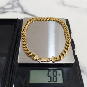 5.8g 18K yellow gold Cuban link bracelet 9 inches on a scale