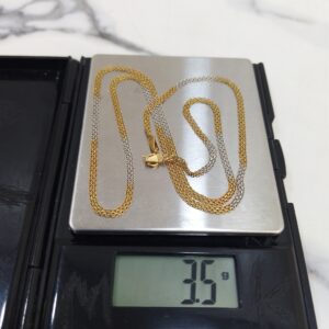 3.5g 18K two-tone yellow and white gold carpet chain 20.2 inches on a scale